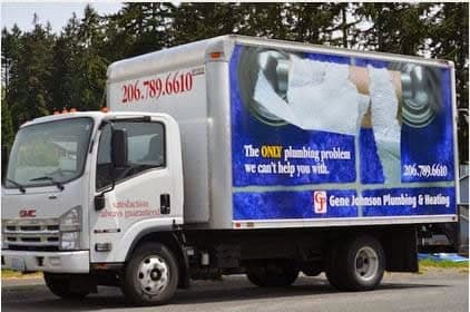 White GMC box truck with blue advertising wrap displaying plumbing services and phone number 206.789.6610.