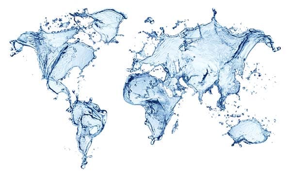 World map created with blue water splashes and liquid droplets on a white background.