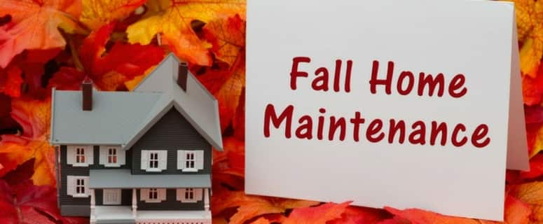 A model house with a white card reading 'Fall Home Maintenance' displayed against colorful autumn leaves.