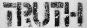 The word TRUTH written or displayed in black letters against a white snowy or powdered surface.