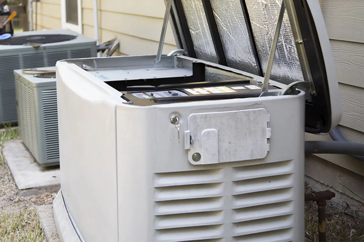 Open white portable generator unit with protective covers and metal frame mounted outside residential home near HVAC units.