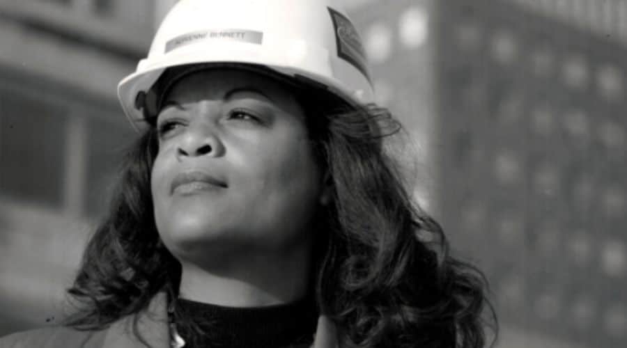 Female plumber with a hard hat on